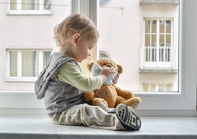 Toddler playing with teddy bear